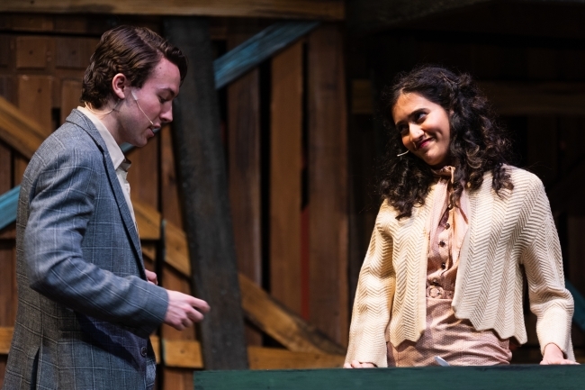 a young man and woman on stage