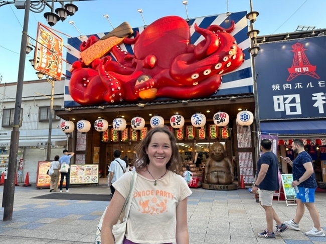 a young woman standing in a Japanese square