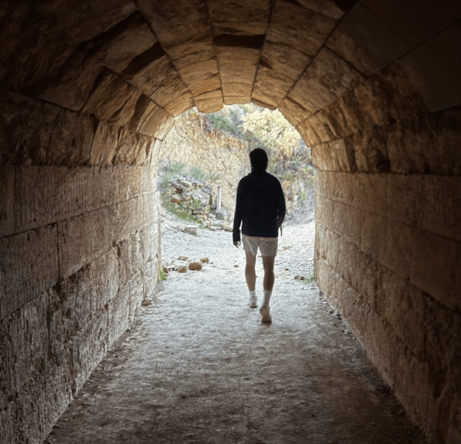 Declan O'Donoghue (‘26) strides through the entrance tunnel of the stadium at Nemea