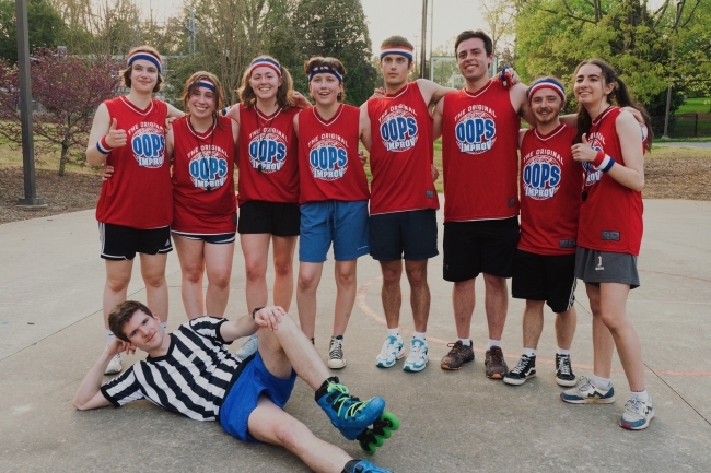 a group of young people wearing basketball uniforms on an outdoor court
