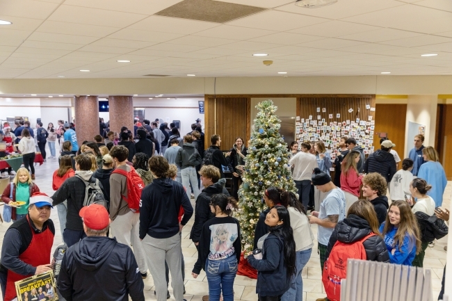 students in a college dining hall decorated for the winter holidays