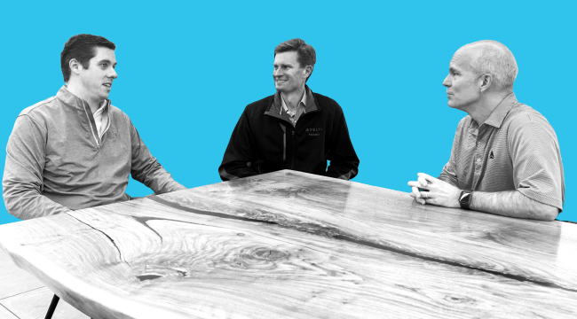 Three men seated at a table