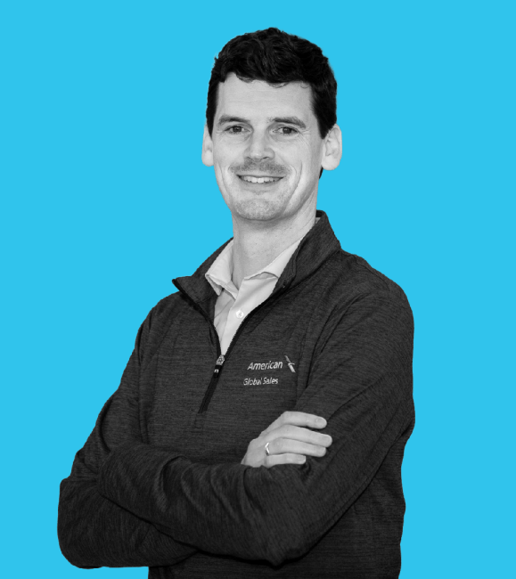 Young white man with arms crossed and dark hair