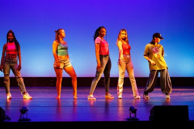 a group of students striking a pose on stage