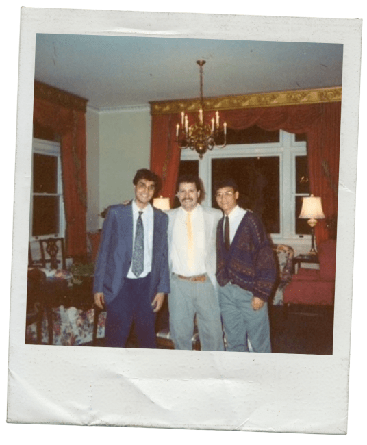 two students and a faculty member together in a college building