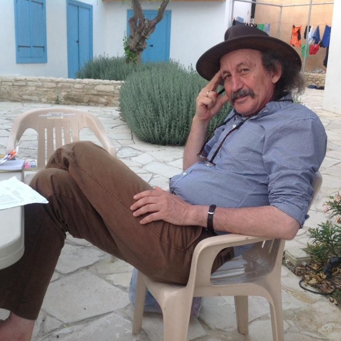Prof. Michael Toumazou sitting in a chair