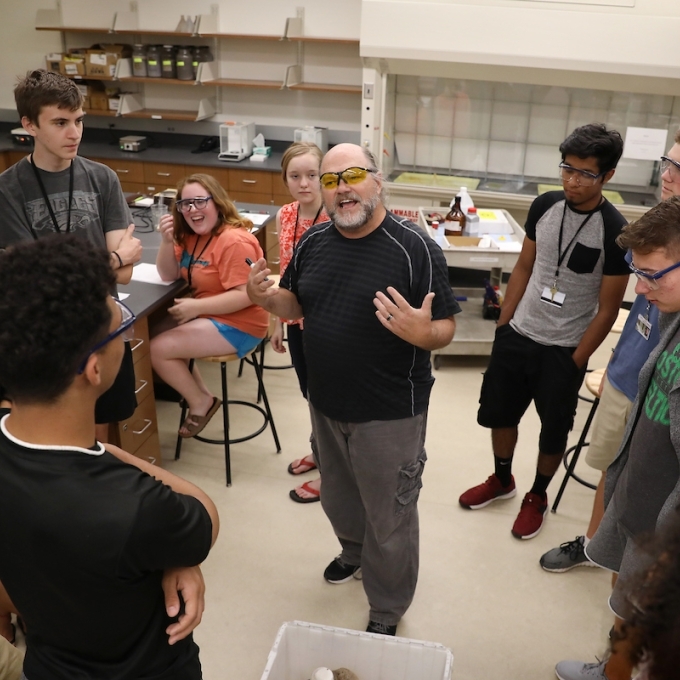 Durwin Striplin in Classroom with Students Gathered Around Him