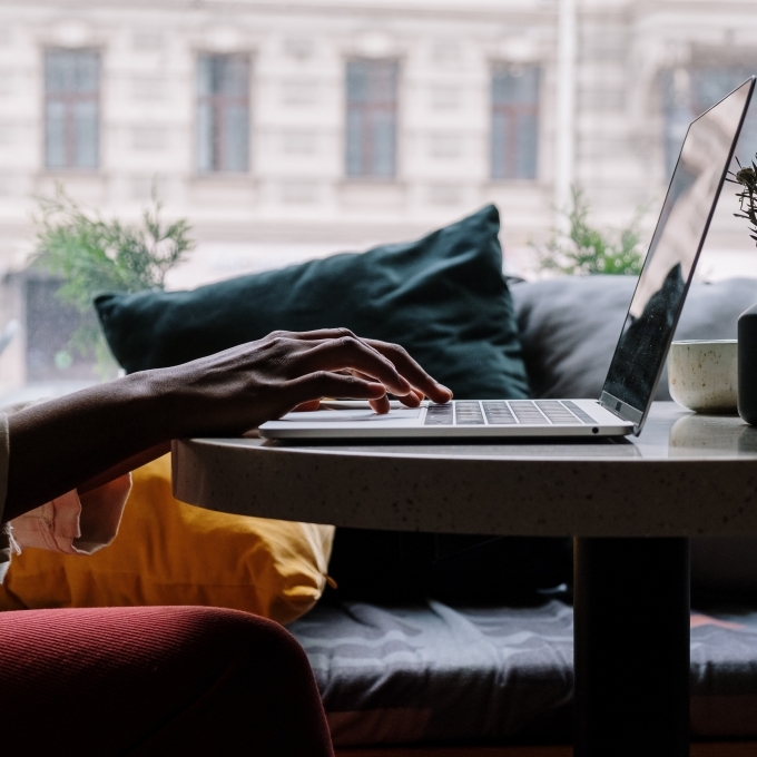 silhouette of hands on laptop