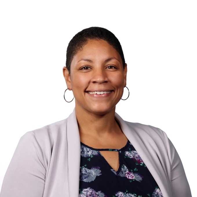a young Black woman wearing a floral top 