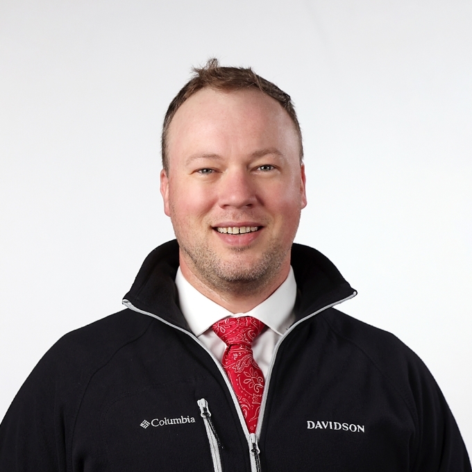 a young white man wearing a tie and jacket