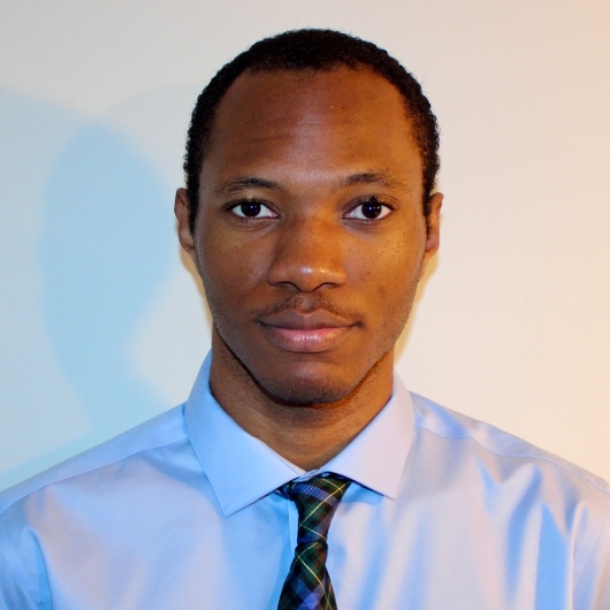 a young man with dark hair wearing a tie and collared shirt