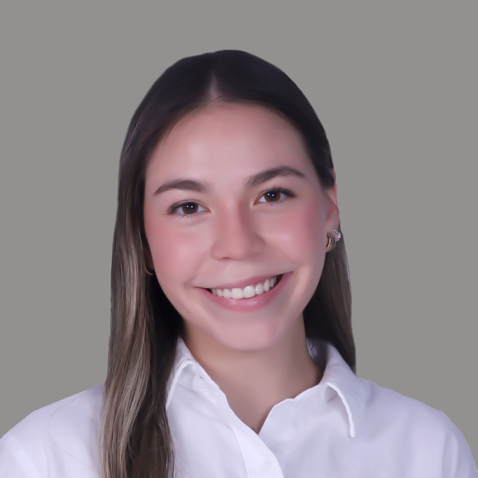 A young woman with long brown hair and a white button down