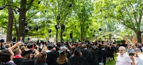 graduation caps in the air on a sunny graduation day