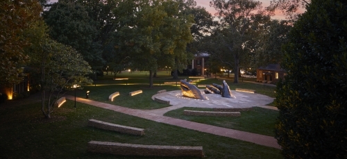 A sculpture in front of a colorful sunset on Davidson's Campus