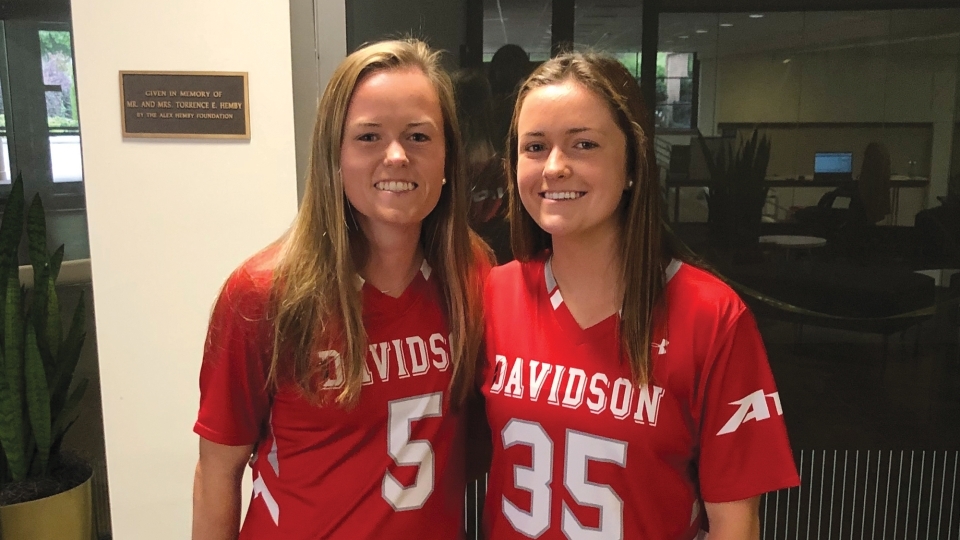 Sisters Olivia and Julianne Carey in Davidson Lacrosse Uniforms
