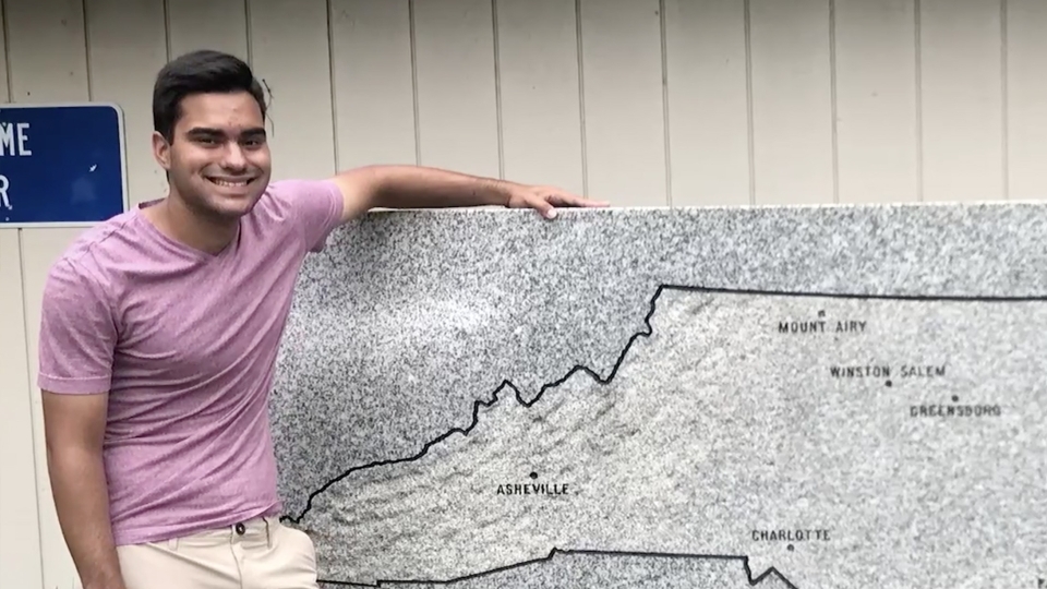 Tim Schietroma '25 in front of a map of North Carolina