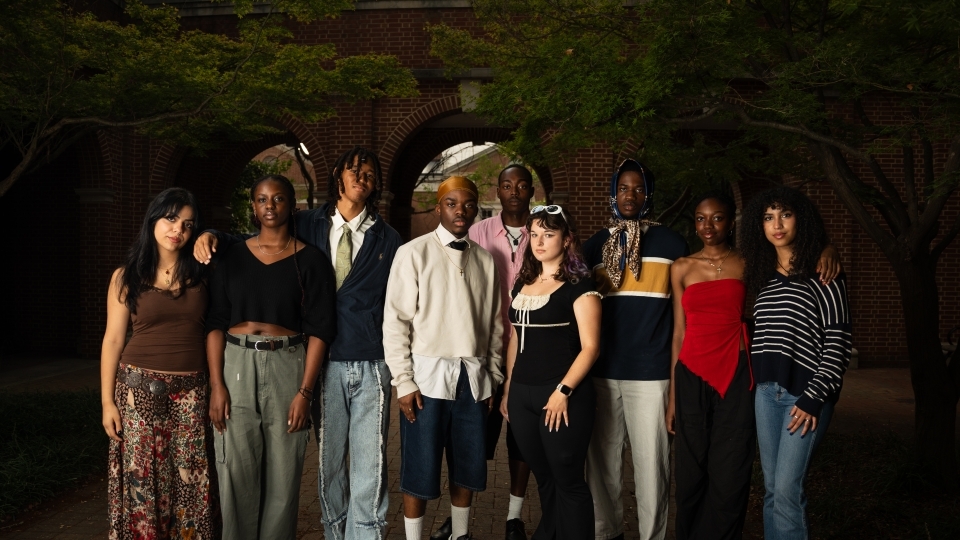 a group of students standing together on a college campus