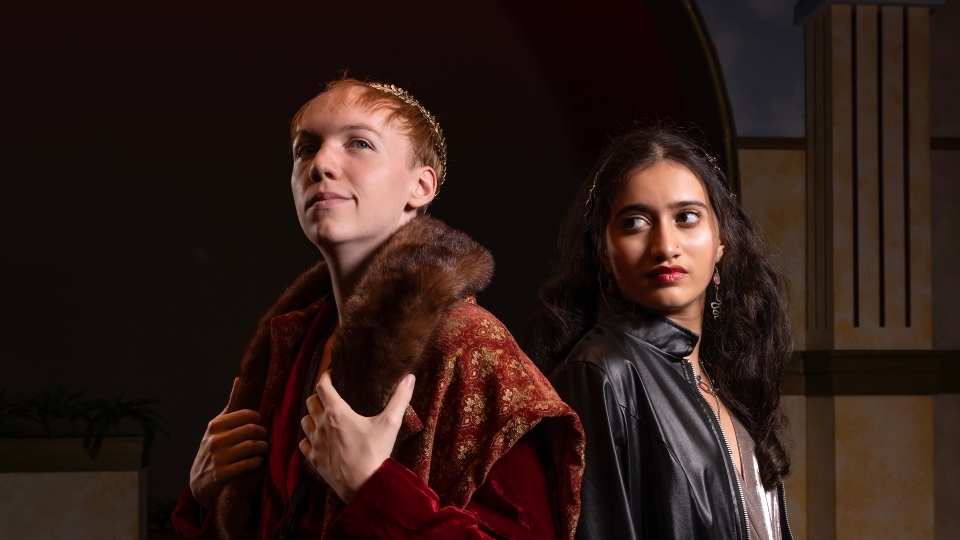 a young man and a young woman in Shakespearean outfits