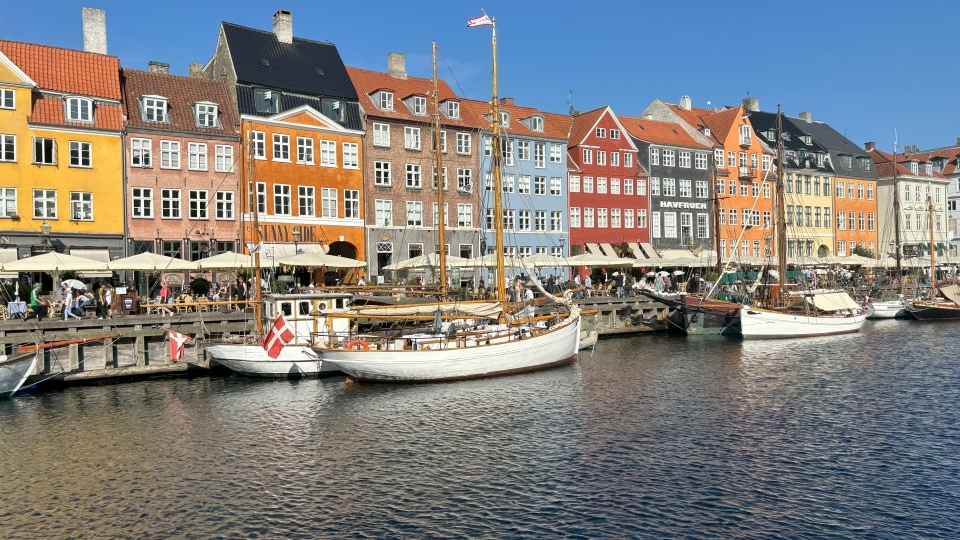 a view of historic Copenhagen - colorful houses and boats along a river