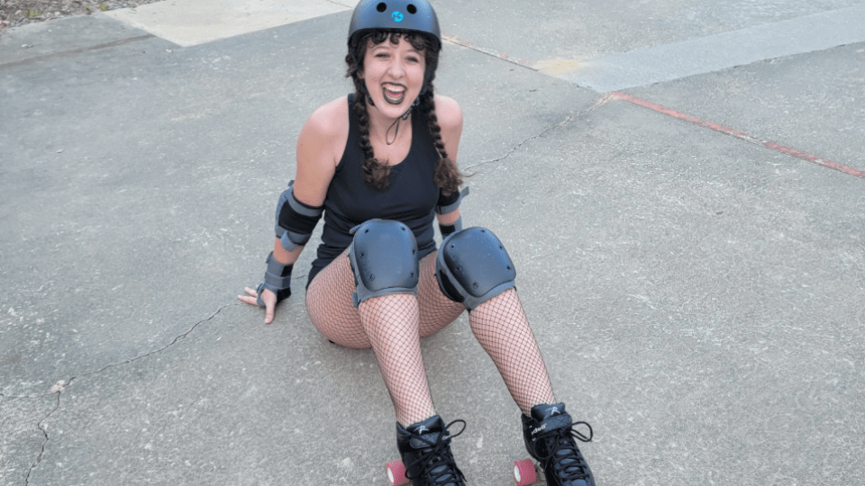 a young woman in roller skates and a helmet smiling