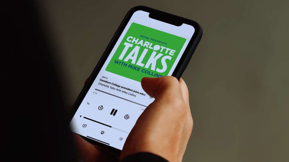 Charlotte Talks podcast playing on phone screen