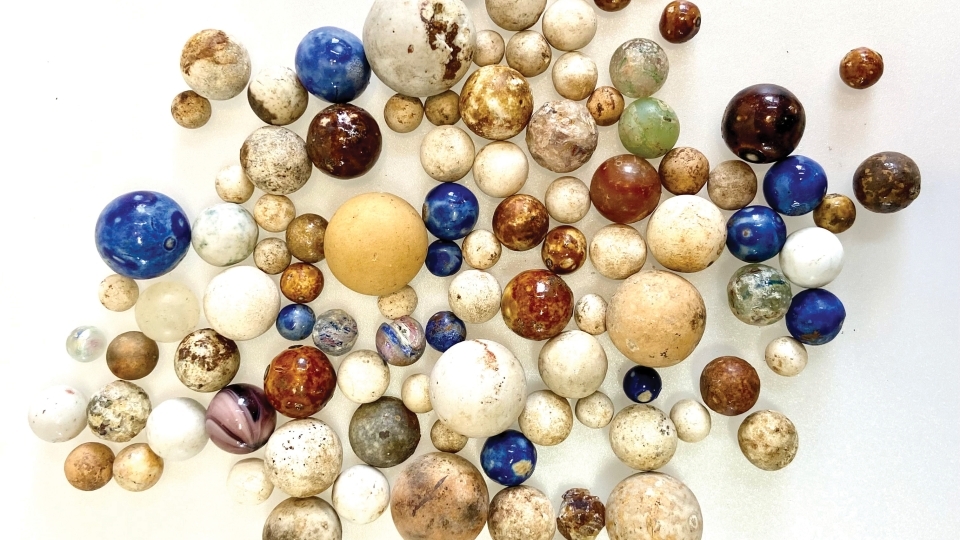Colorful marbles of all sizes on a white background