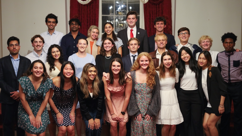 A group of diverse university students in semi-formal attire pose for a multi-row group portrait during a 2026 Student Government Association meeting.