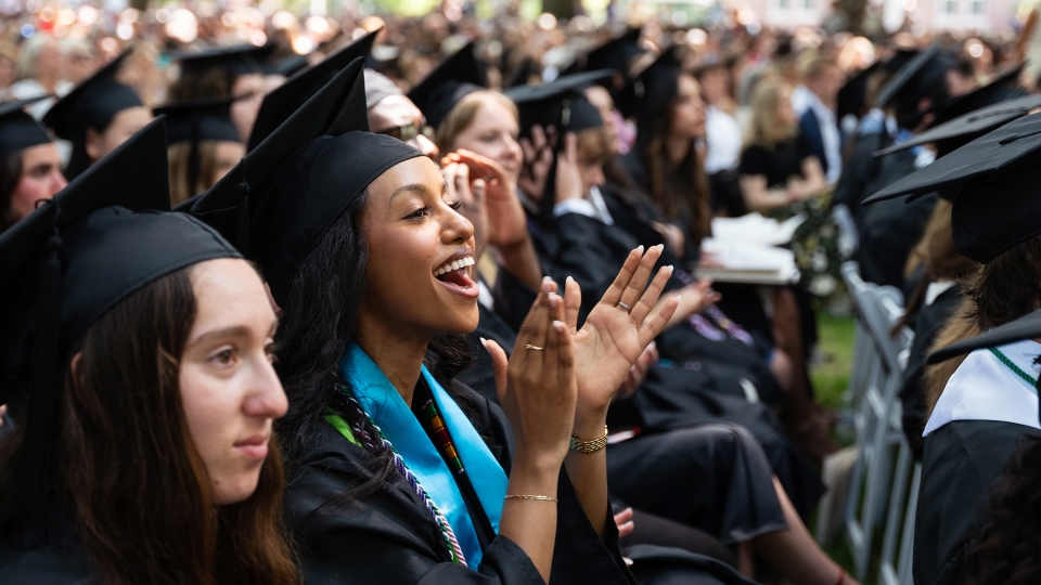 Student smiles and claps at Commencement 2026
