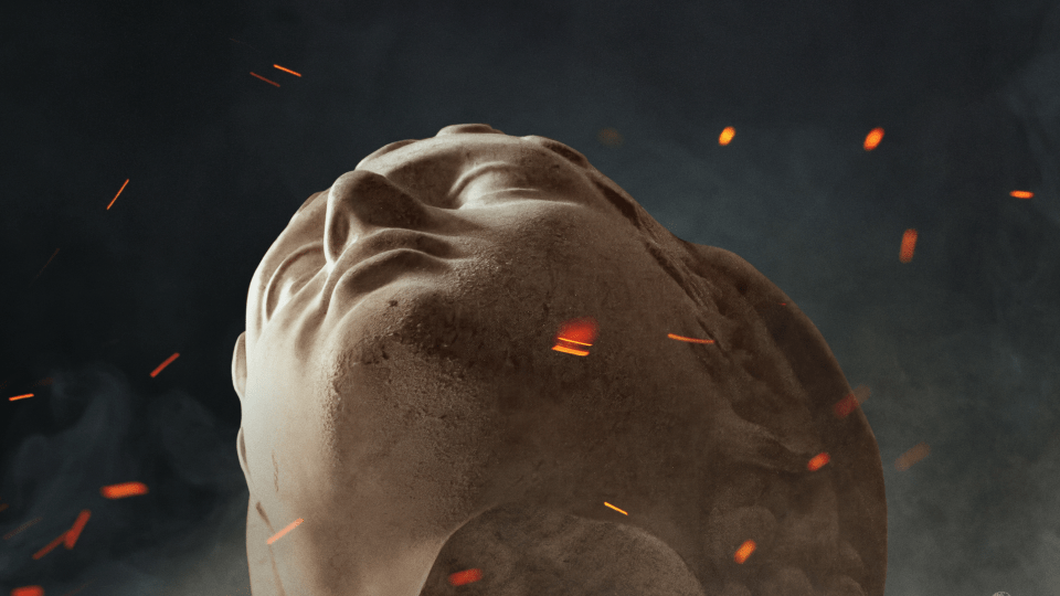Close-up, low-angle view of a stone classical bust tilted backward against a dark, smoky background with floating orange embers