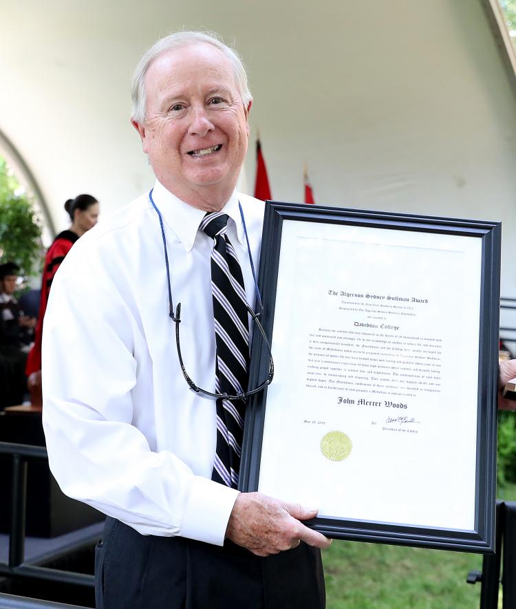 John Mercer Woods holds award plaque 