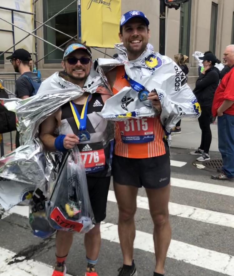 Physics professor and friend pose with medals at end of Boston Marathon