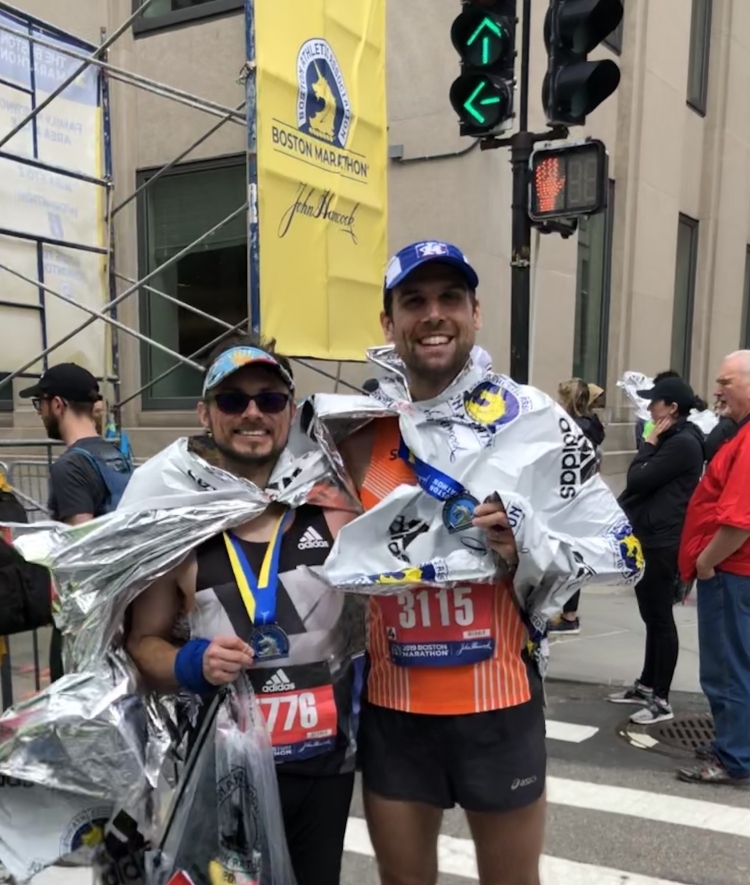 Physics professor and friend pose with medals at end of Boston Marathon