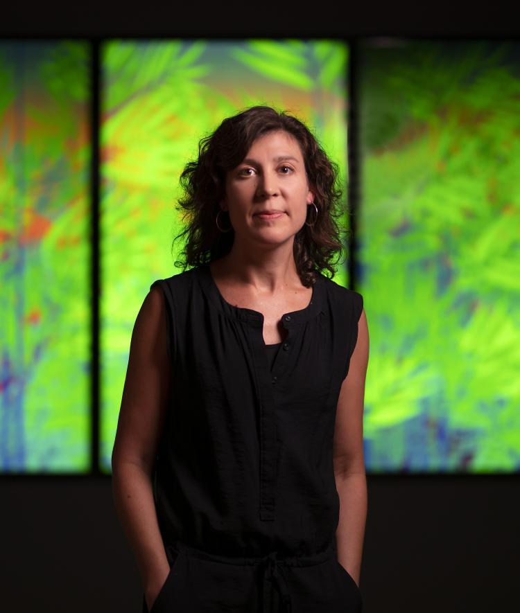 Joelle Dietrick in front of lighted art panels