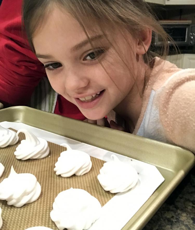 Selfie of Hattie Deering with a sheet of cookies