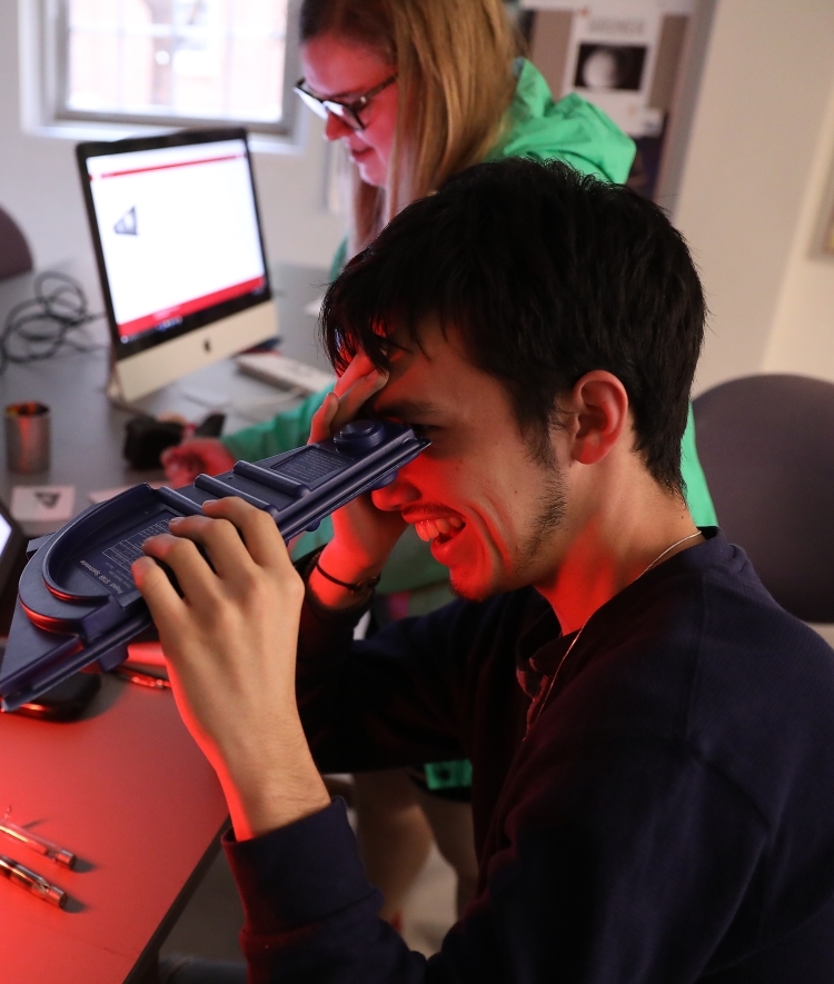 Student looks through physics apparatus