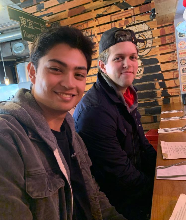Matt Frey and Zach Nussbaum in a restaurant 