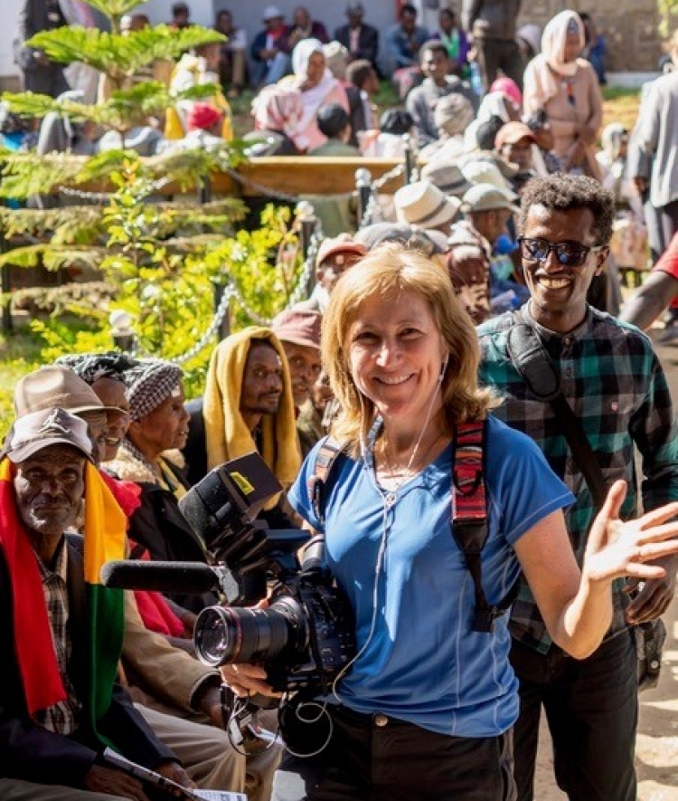 Mary Olive Smith Surrounded by People with Camera