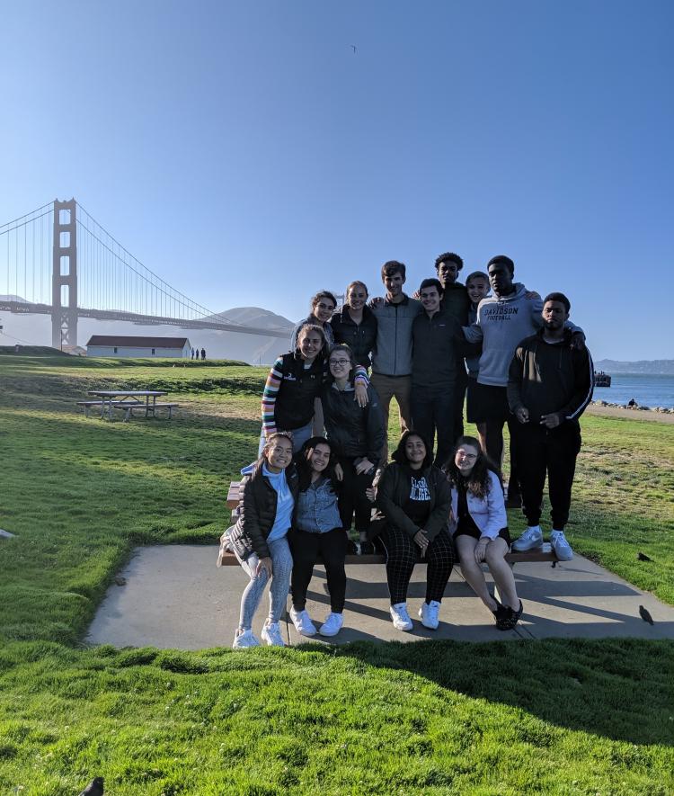 group of students with bridge backdrop 