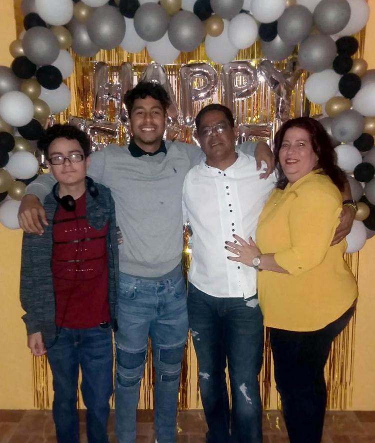 Israel Palencia and Family pose by new year balloon arch