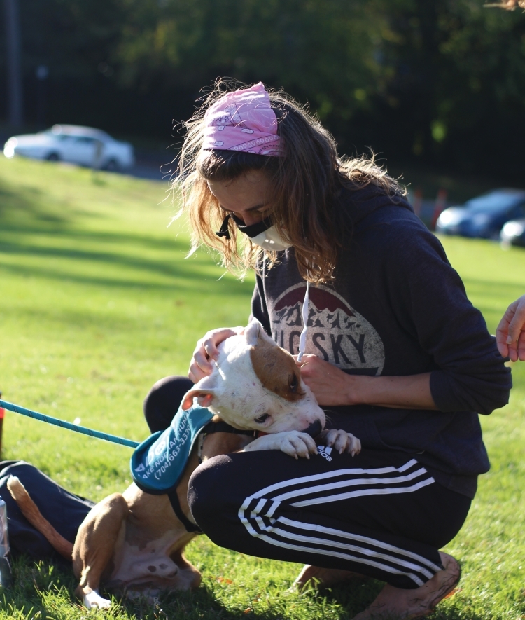 Student with Mask pets dog