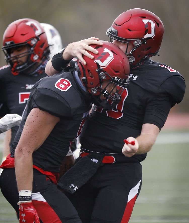 Two Football Players Hug to Celebrate Touchdown