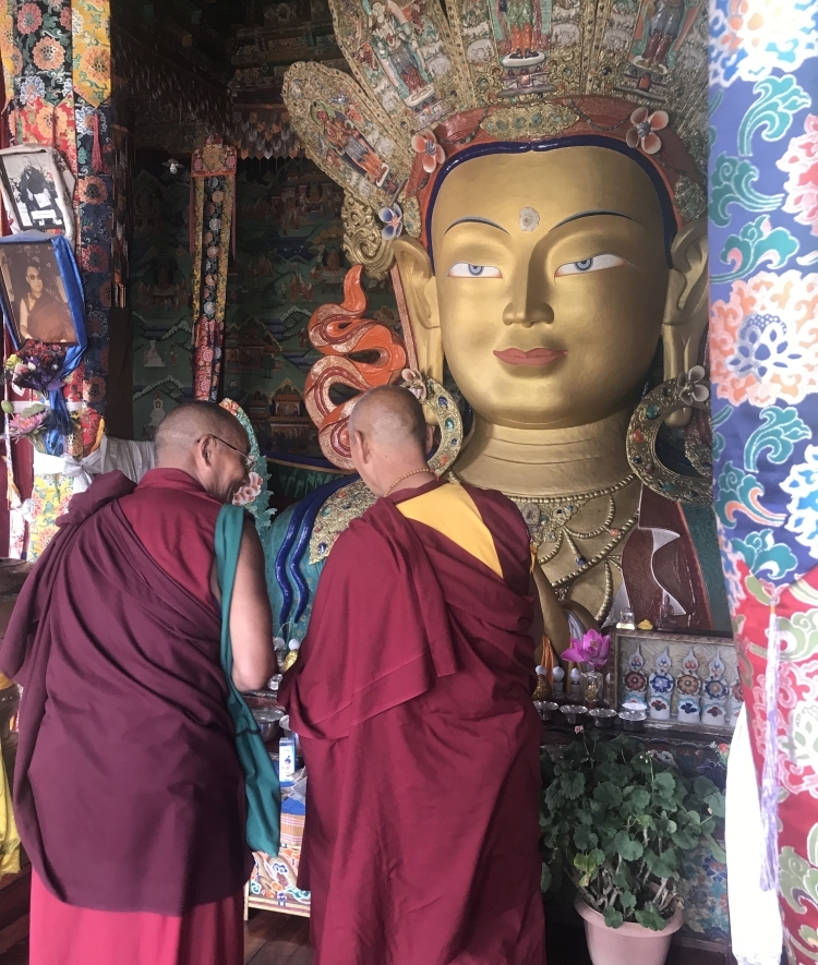 The backs of two Buddhist monks at Thikse Monastery in Ladakh, India