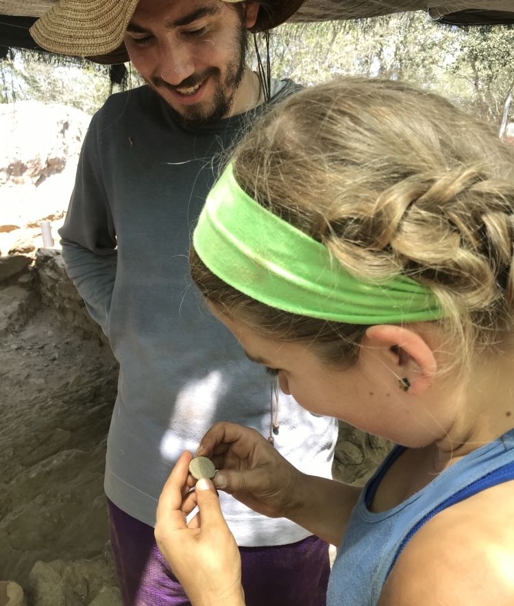 Davidson student Eleanor Lilly holds Roman coin