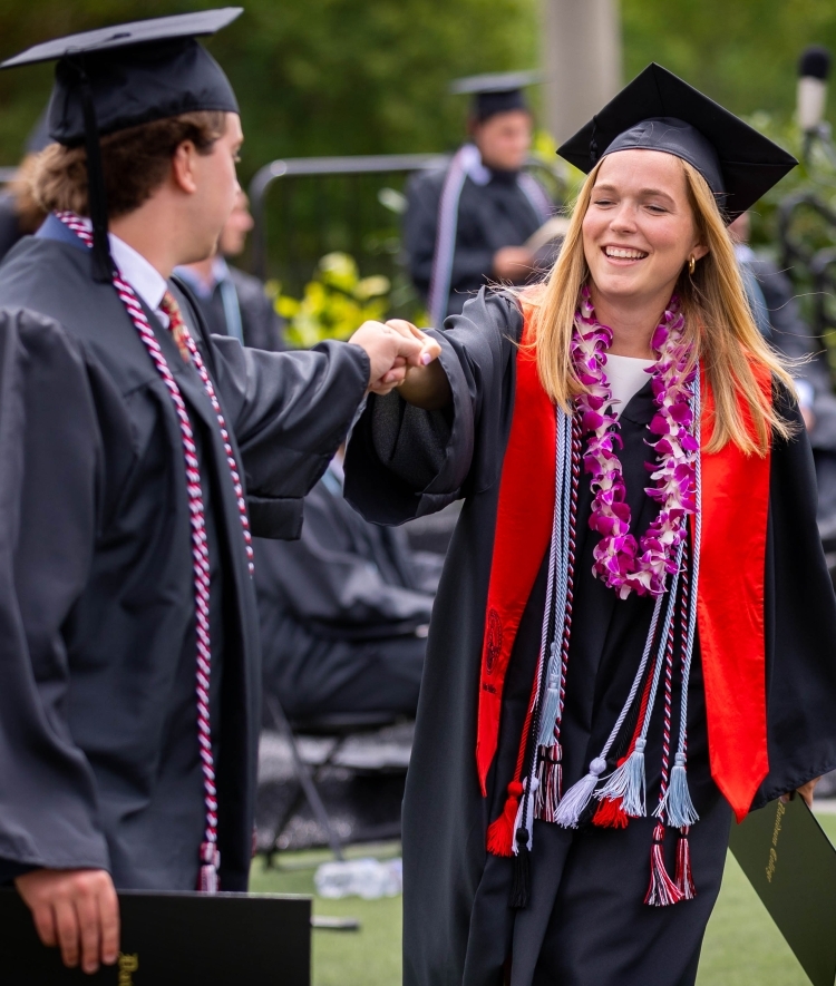 Friends Fist Bump at Commencement