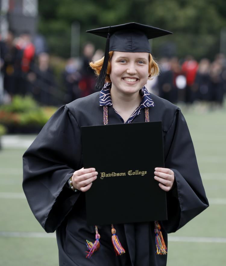 Student at Commencement Holding Diploma