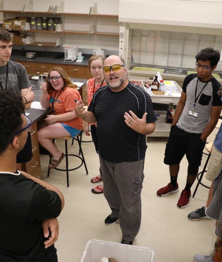 Durwin Striplin in Classroom with Students Gathered Around Him