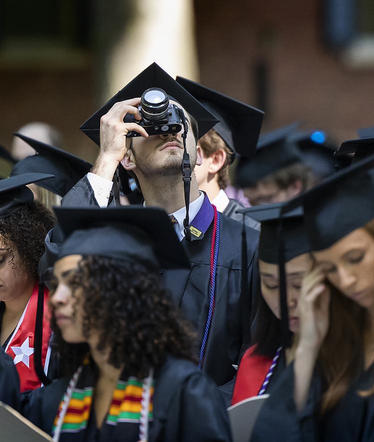 Student taking picture with camera at Class of 2022 Commencement