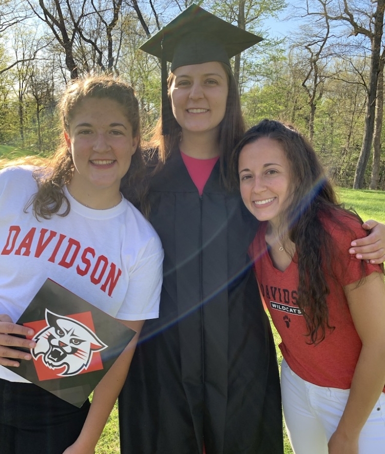 Eldina '20 in her cap and gown with sisters Elisa '23 and Esada