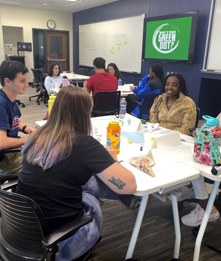 students sitting at table during Green Dot Training