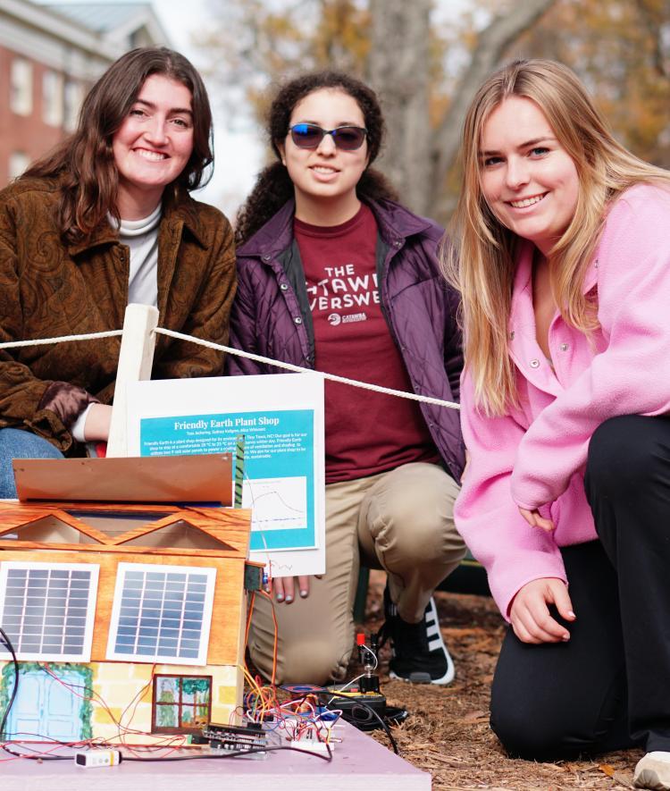 three students with solar powered tiny town